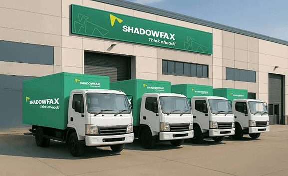 Shadowfax branded facility with delivery trucks parked in front